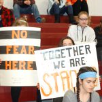 Students holding signs at the high school walk out rally