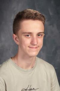 student with short hair and tan shirt