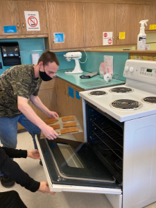 Student unloading stove