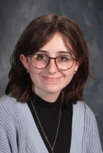 student with glasses and gray top