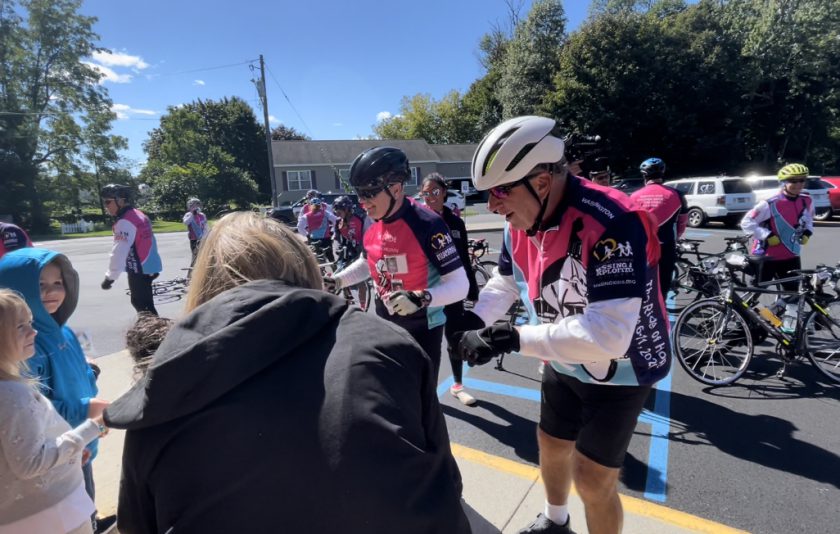 cyclist greeting students