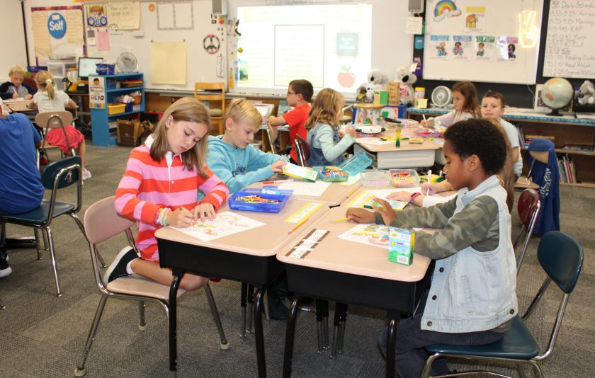 students working on a project as they sit at desks