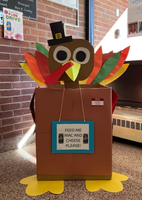 a xardboard box with a colorful turkey character glued to box