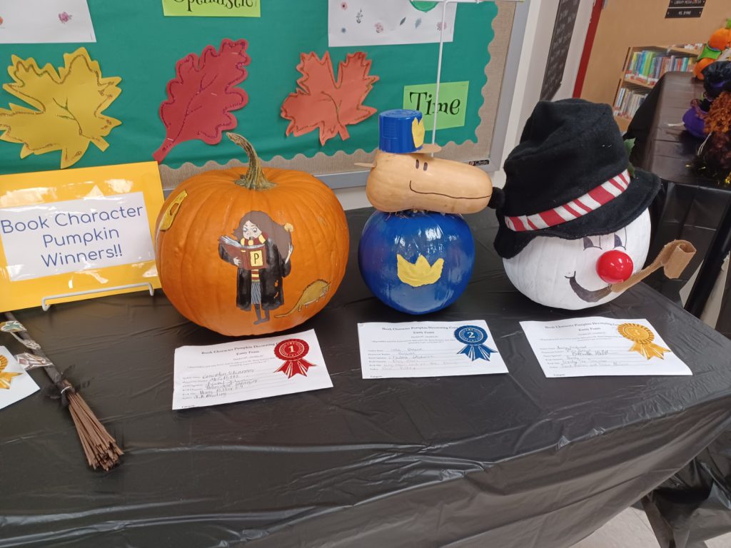 one pumpkin decorated with a harry potter character, one decorated like a dog in a cop outfit, one pumpkin decorated like a snowman