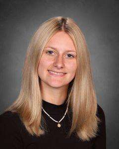 student with long blonde hair with head slightly tilted