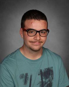 student with faint mustache and black rimmed glasses