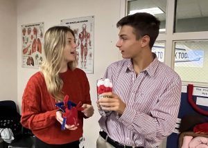 two students looking at each other and talking 