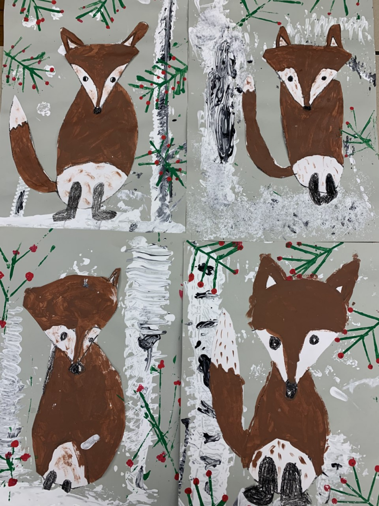 four drawings of foxes with a snow and holly background