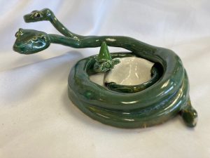 a green ceramic snake with three heads