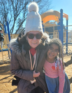 woman and student out on the playground smiling 