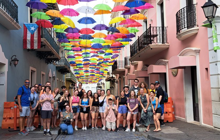 a group of students standing below colorful umbrellas in Puerto Rico