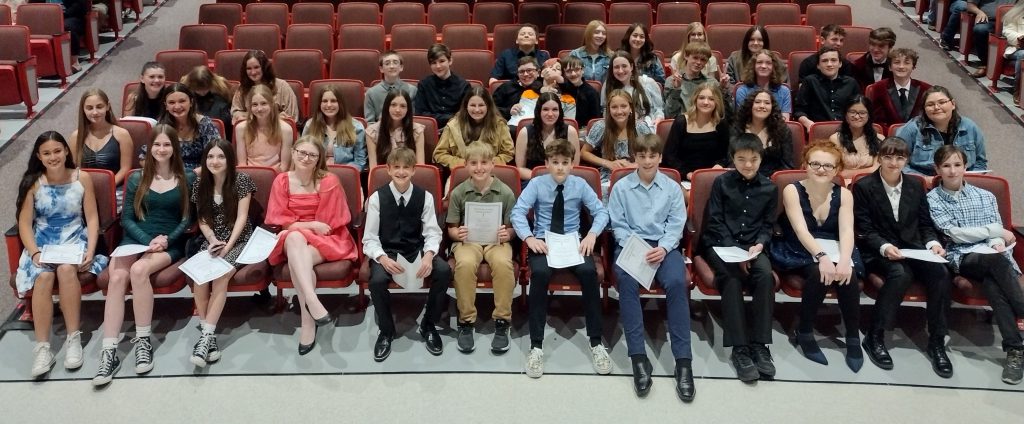 students sitting together in auditorium seats