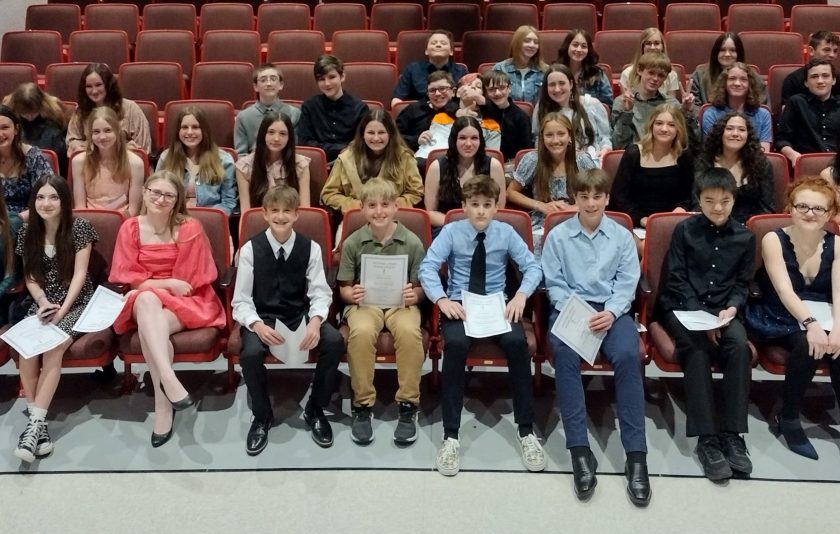 students sitting together in auditorium seats