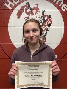 girl smiling and holding a certificate