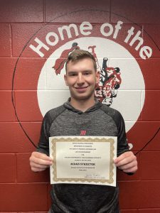 boy holding certificate and smiling