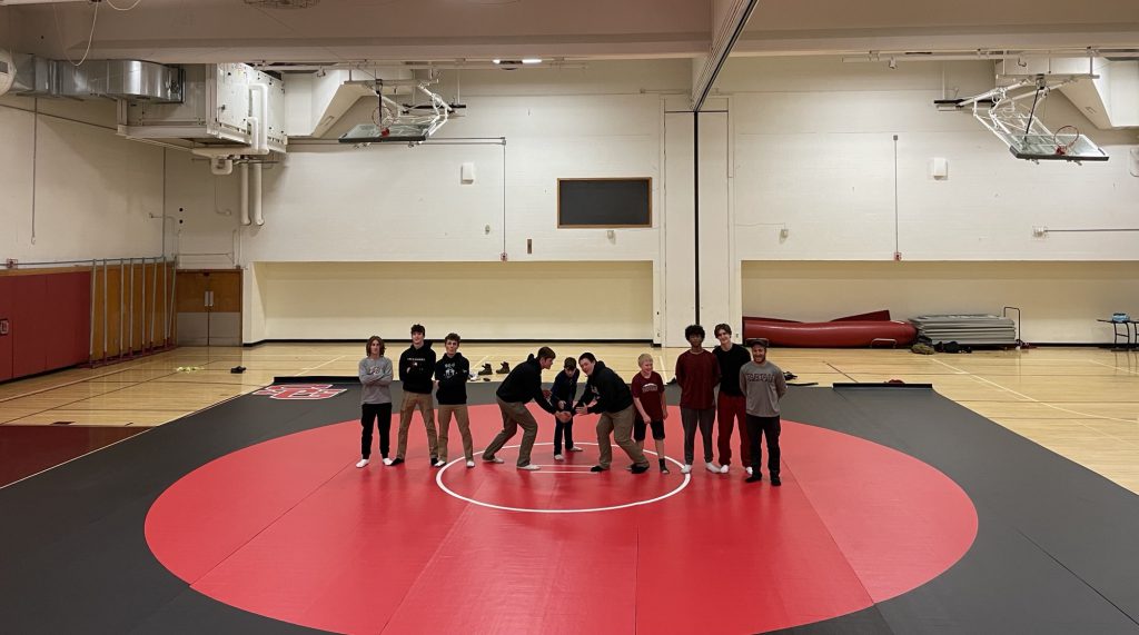 wrestling team standing on their new mats