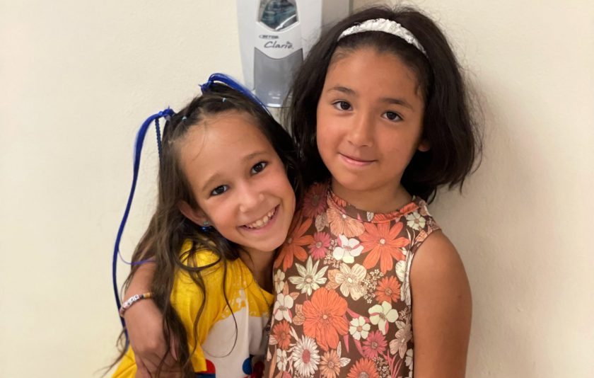 two students with their arms around each other