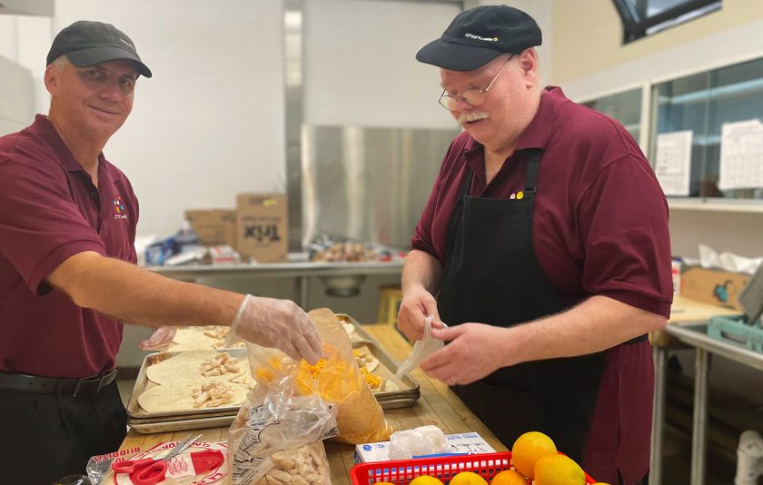 two workers making lunch