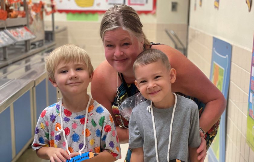 teacher and two students get a snack from the cafeteria