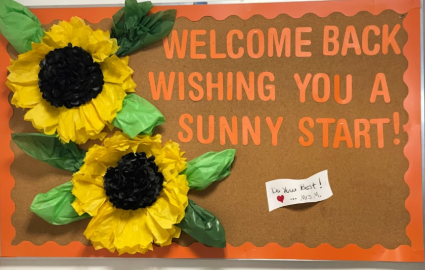 board with two sunflowers and the words welcome back wishing you a sunny start