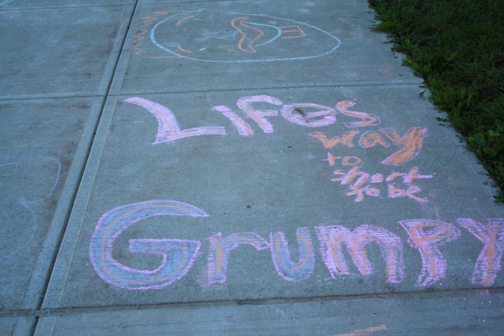 words written in pink, orange, and purple chalk saying, Life's way too short to be grumpy