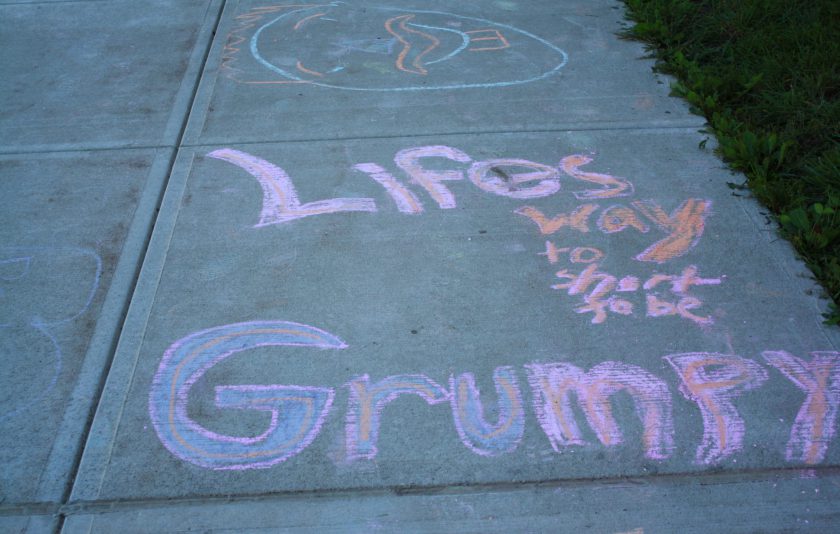 words written in pink, orange, and purple chalk saying, Life's way too short to be grumpy