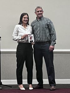 HOF recipient holding award with SG coach