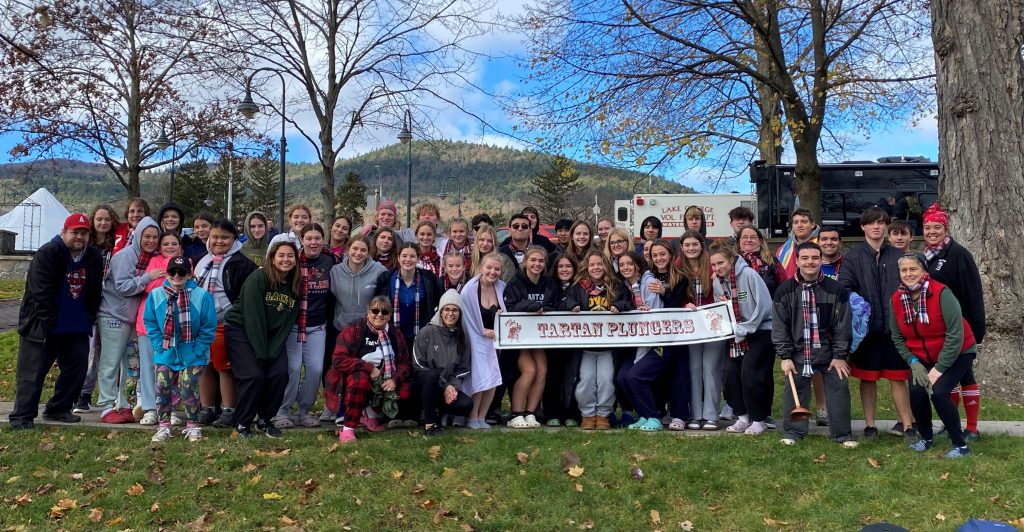 group of students and adults standing close together outside