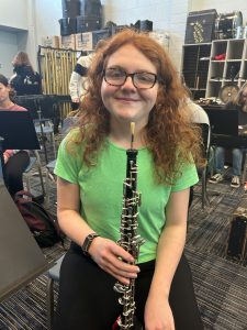 student holding an instrument 