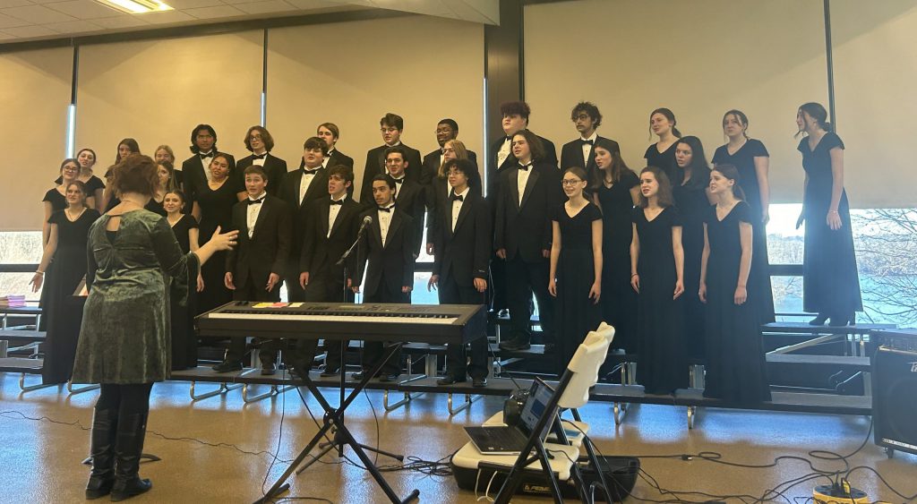 singing on a tiered platform