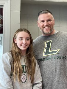 student athlete smiles with coach
