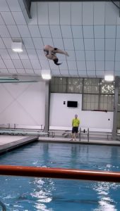 diving off a board into pool