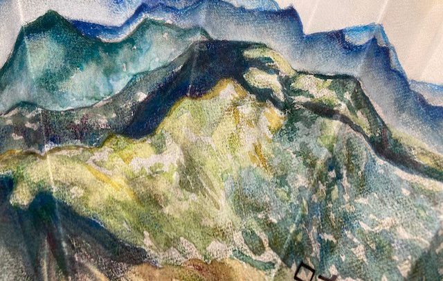 close up of texture of art that looks like a mountainous world in earth colors of shades of blue, and greens and browns and yellows.