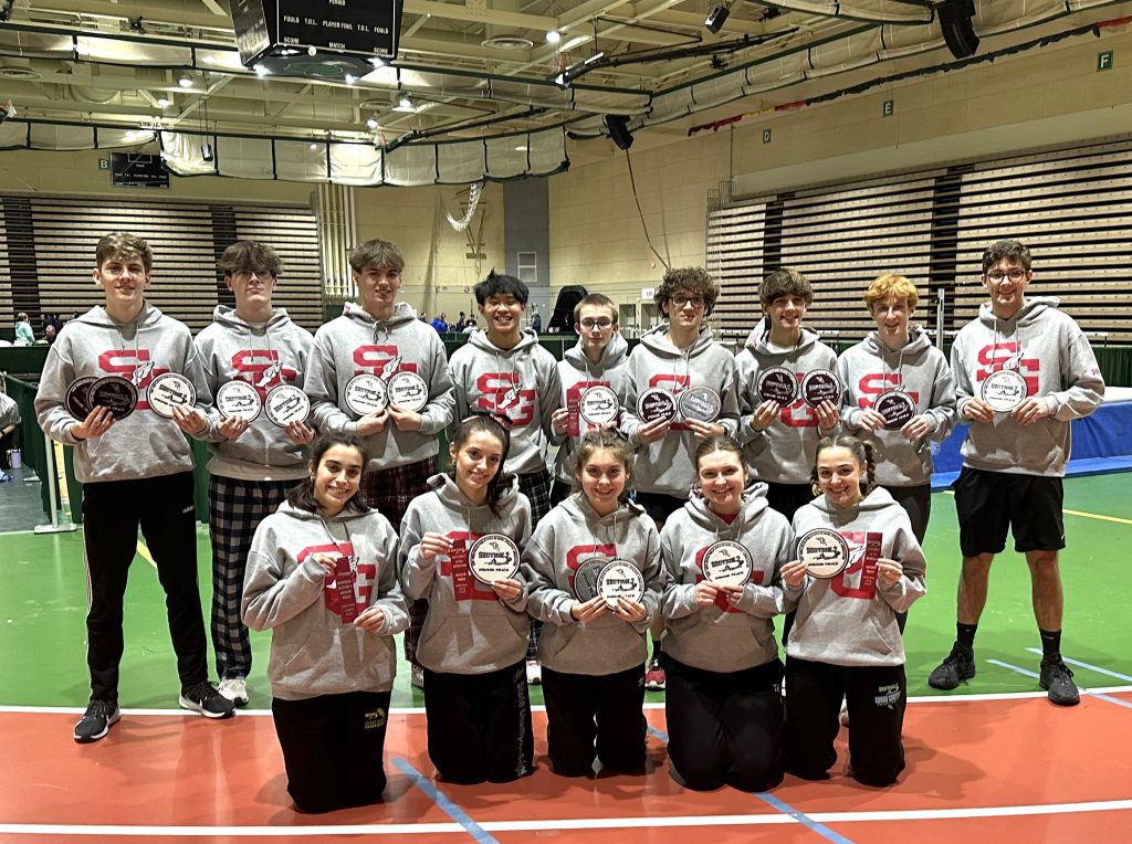 boys and girls track stars wearing warm up uniform and holding their section 2 awards