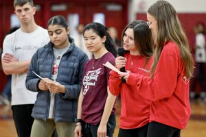 students speaking at assembly