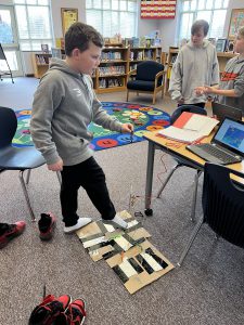 student testing a video game footpad he created