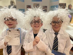 three young students dressed as scientists