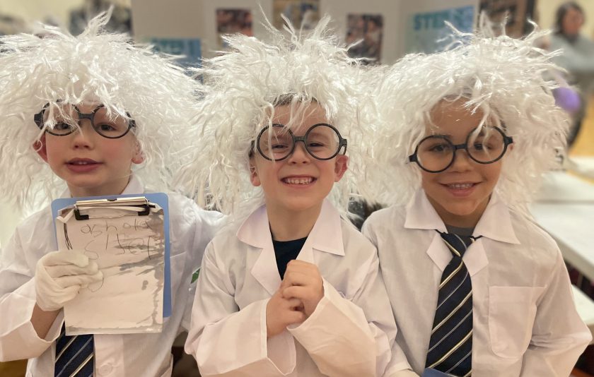 three young students dressed as scientists