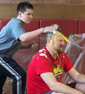 student smashes egg on teachers head