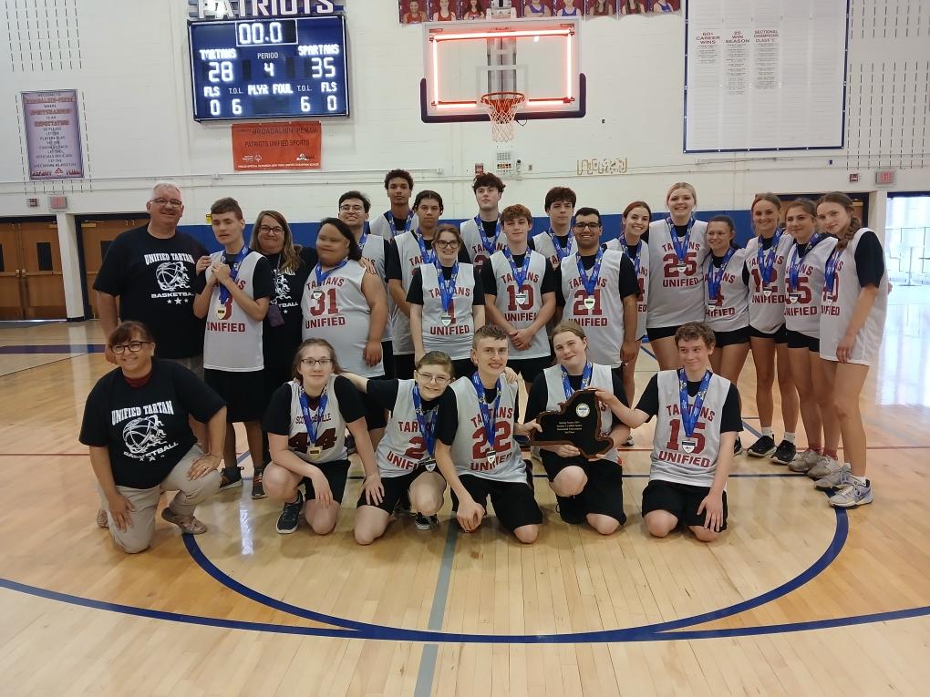 basketball team together on gym floor