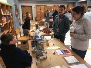 teachers reading poetry and speaking with student who created them